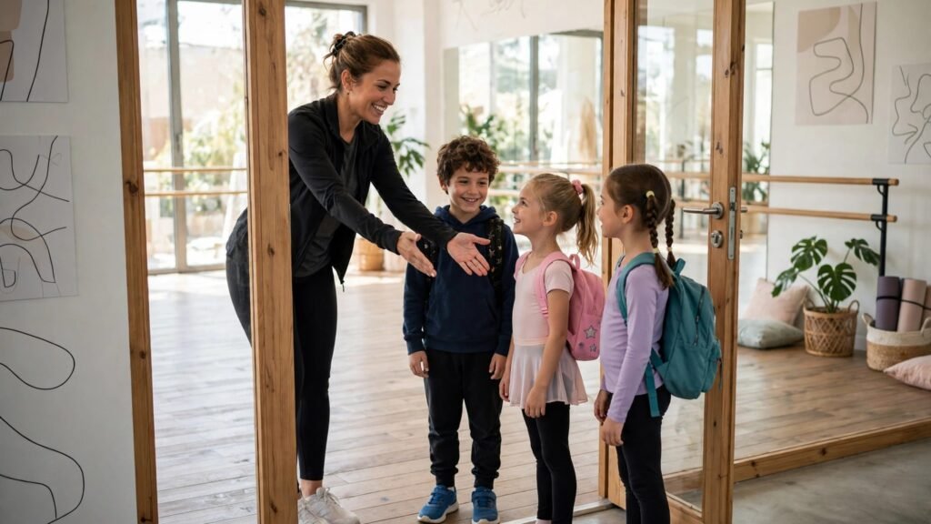 Dance teacher greeting students at a studio door